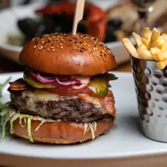 Burger with fries and salad on a plate