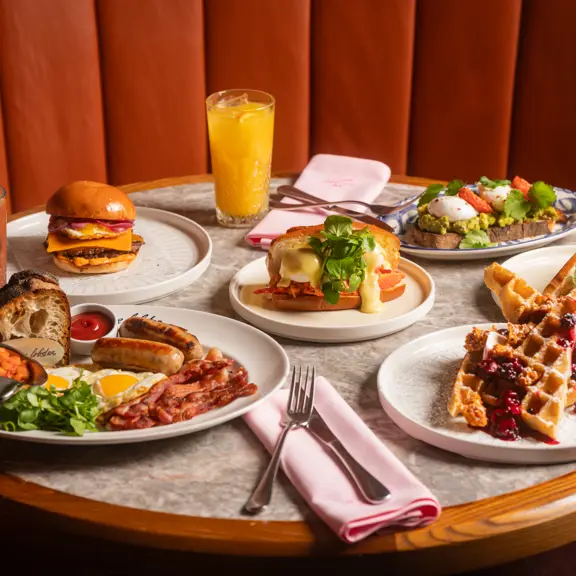 Burger & Lobster brunch menu plates of food with drinks on table