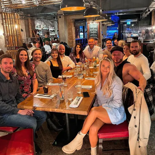 Group of people smiling at Burger and Lobster